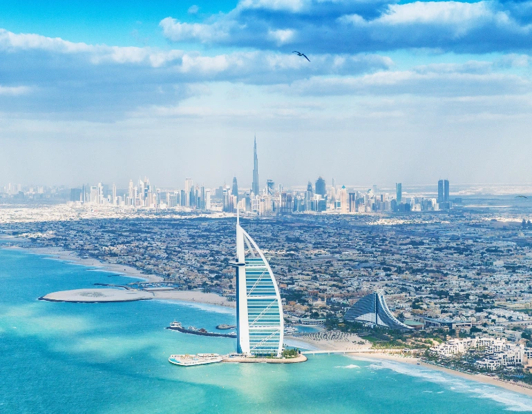 Dubai skyline with Burj Al Arab and coastal view, representing premium real estate opportunities