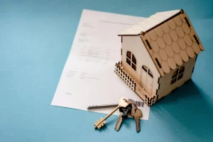 Property management concept with house model and keys representing rental property services